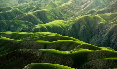 This photo captures a breathtaking view of rolling green hills, where the interplay of light and...