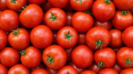 A vibrant and close up view of a collection of fresh ripe red tomatoes with their green stems attached filling the frame