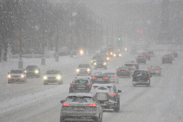 Cars on the road during a snowstorm.  winter.