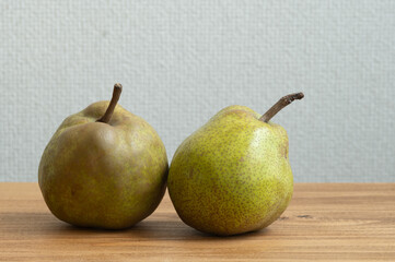 木製のテーブルの上に置かれた2個の洋梨