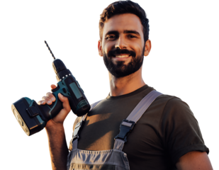 Smiling bearded man in olive t shirt and grey overalls holding a black and teal cordless drill, looking at camera,, isolated on white background