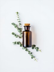 Eucalyptus essential oil in dark glass bottle with fresh green leaves