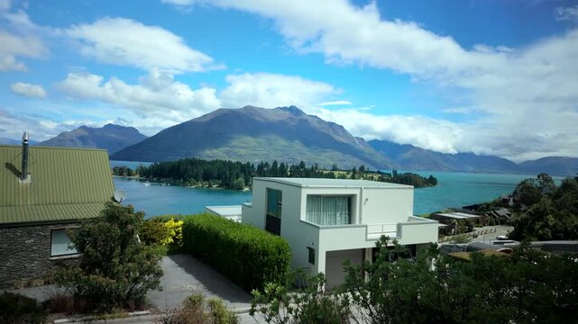 Lakeside neighborhood view with modern house and mountain range