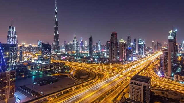 Stunning Nighttime Cityscape of Dubai with Illuminated Skyscrapers and Highways.