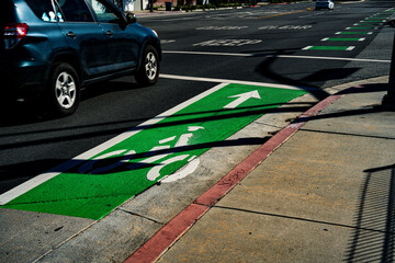 Bright green bike lane with cyclist symbol and arrow guides cyclists safely
