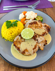 Plated Dinner with Meat Medallions, Rice and Carrots on Blue Plate
