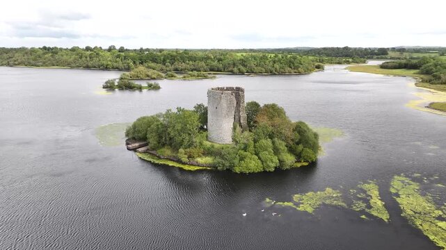 Dynamic aerial panorama of Cloughouter Castle on island, Navan, Ireland. History, tourist attraction