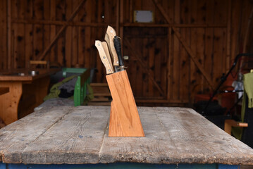 Rustic wooden knife block holding a set of  kitchen knives for farmhouse kitchen storage and decor