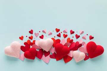 Valentine or Mother's Day day blue background with red and pink hearts top view. Festive mockup or template for design and promotion.