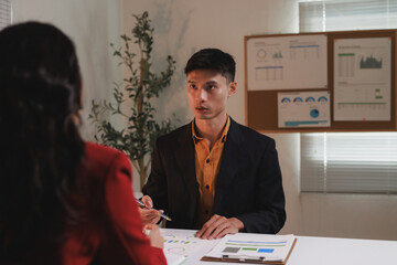 Business professional discussing financial data during office meeting