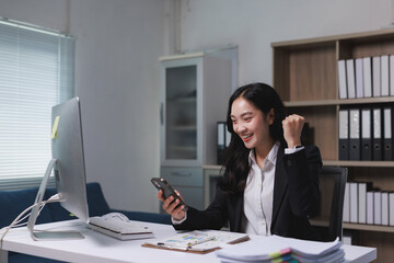 Young businesswoman celebrating business success receiving good news