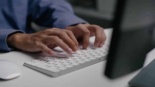 Closeup of Businessman hands working and typing on laptop computer keyboard on office table for data analysis, internet marketing, online studying, writing article, and accounting.