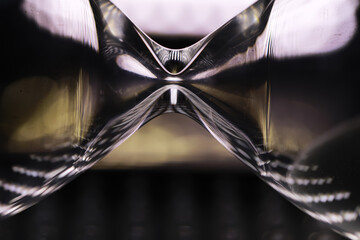 Abstract Hourglass Shape with Dramatic Lighting and Fluid Reflections in Modern Art Photography