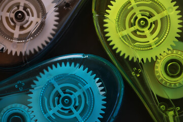 Close-Up of Vibrant Colorful Tape Dispensers with Exposed Gears in Office Setting