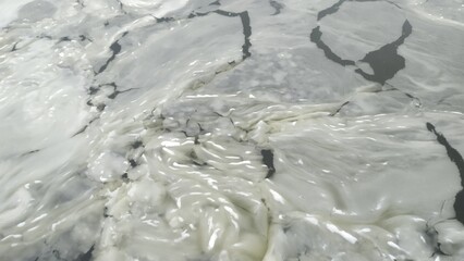 Abstract Texture of Slushy Melting Ice Floes and Cracks on Frozen Water Surface_1