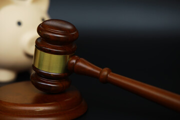 Wooden Gavel and Piggy Bank Symbolizing Financial Law and Justice Concepts