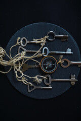 Vintage Keys and Compass on Slate: Exploring Direction and History