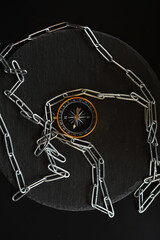 Compass Wrapped in Chain on Dark Background: Direction, Security, and Navigation Concept
