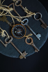 Vintage Keys and Compass on Slate: Exploring Direction and Discovery