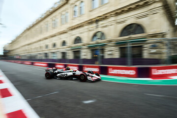 Obraz premium BAKU, AZERBAIJAN - SEPTEMBER 20, 2025: Nico Hulkenberg drives the MoneyGram Haas F1 Team car during the Azerbaijan Grand Prix.