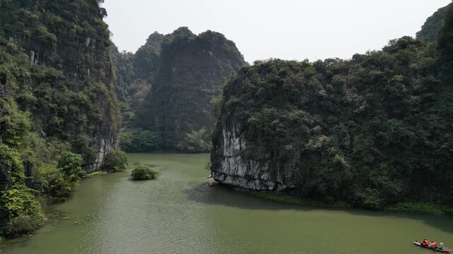 Aerial view of boats along river through karst landscape in Ninh Binh