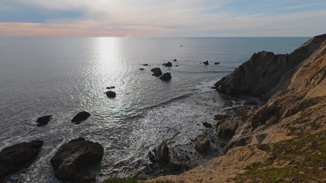 Sunset Over the Rugged Cliffs and Distant Boat at Bodega Head