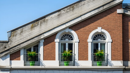 Classic brick building with arched windows and greenery