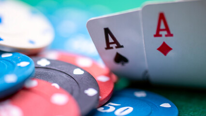 A deck of playing cards with the Ace of Aces on top. The cards are scattered on a green table