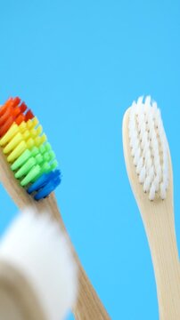 Assortment of biodegradable toothbrushes with vivid and monochrome bristles. Contrast of style and function. Concept of green lifestyle, routine, and conscious consumer habits