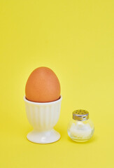 カラフルな背景にエッグスタンドに置いた卵