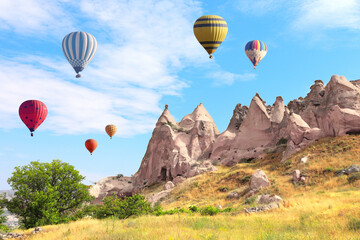 Balloon flight, famous tourist attraction of Cappadocia. Air balloons and Fairy Chimney in Pasabag Valley, Anatolia, Turkey. Topic of vacation, travel, trip abroad on vacation, cruises and tours