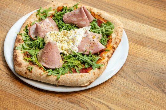 Mortadella pizza is a popular Italian composition with mozzarella and mortadella.