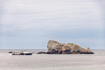 Vessel on the sea by a rock on the sea