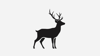 Obraz premium Silhouette of a majestic stag with large antlers standing proudly.