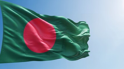 Flag of bangladesh waving in the blue sky with sunlight