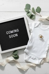 Baby Onesie with Coming Soon Announcement Sign