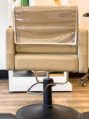 Plastic Covered Salon Chair on Wood Floor