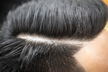 Close up view of a short, freshly cut men hairstyle.