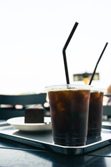 Two cups of iced Americano. Cold tasty summer refreshment beverage concept