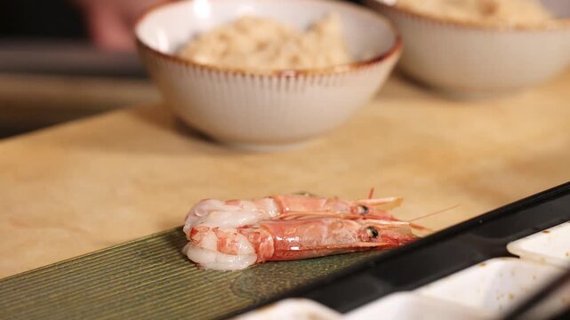 Professional Sushi Chef Preparing Fresh Ebi Nigiri in Fine Dining Restaurant