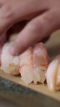 Chef Preparing Fresh Ebi Shrimp Nigiri Sushi at Omakase Bar