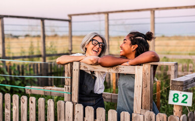 Diverse women friends laughing together in community garden