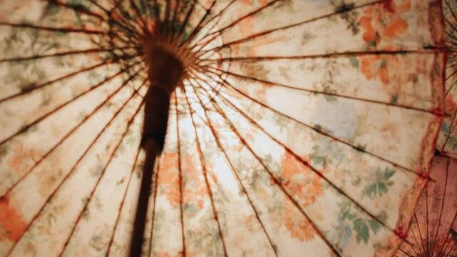 Vintage Asian parasols with floral patterns against bright background
