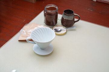 Preparing for pour-over coffee with fresh grounds and filters on a table