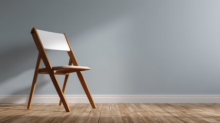 A minimalist wooden folding chair stands elegantly on a warm wood floor against a plain light gray wall. Modern Scandinavian design emphasizes clean lines and natural materials, making it a versatile