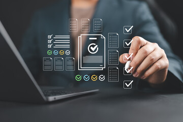 Businessman checking off a digital checklist on a virtual interface, representing task management,...