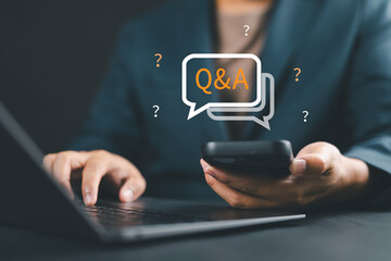 Businessman clicking a QA or FAQ button on a digital platform, symbolizing question and answer communication, information access, and customer support through frequently asked questions.