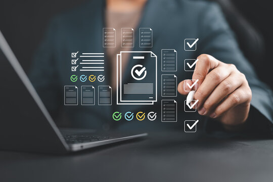 Businessman checking off a digital checklist on a virtual interface, representing task management, workflow optimization, productivity, audit, compliance, and digital transformation.
