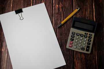 Calculator with Blank Paper on Wooden Desk