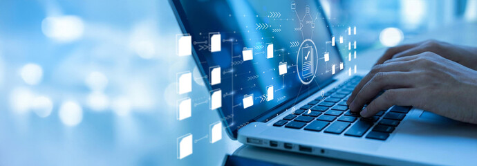 A businesswoman utilizes a laptop to manage digital files, employing online documentation and database technology. This represents concepts like record keeping, file access